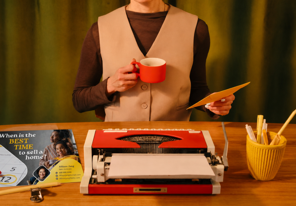 An L&B team member reviewing a campaign postcard before it goes to print
